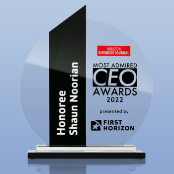 A white, black, and red award in front of a light blue background.