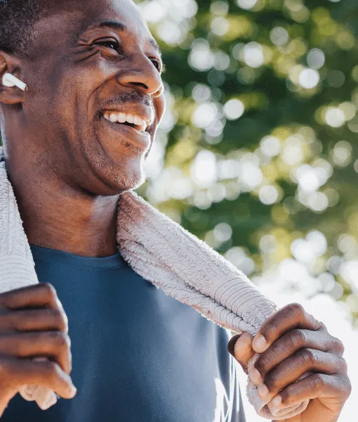 Man looking to the right with a towel around his neck.